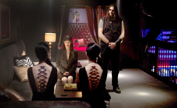 The Soska Sisters (Sylvia and Jen) ask Mary (Katherine Isabelle) for some radical body modifications in American Mary (2012) while Lance (Twan Holliday) stands guard.