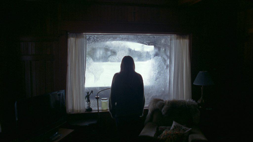 Riley Keogh is trapped in a cabin in the very frozen woods in The Lodge (2019). (Or is she?)