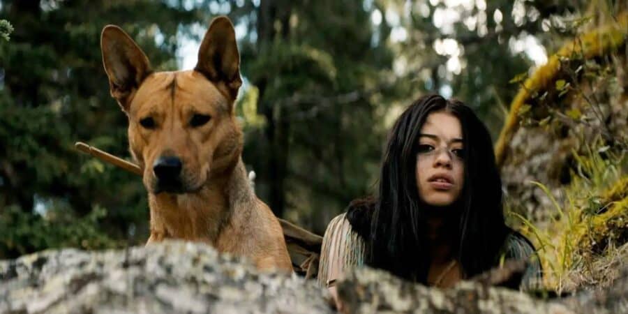A dog and a woman in a forest setting, evoking a horror movie atmosphere.