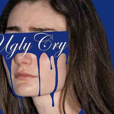 A woman with a distressed expression, partially covered by a blue sign reading "Ugly Cry" with dripp.