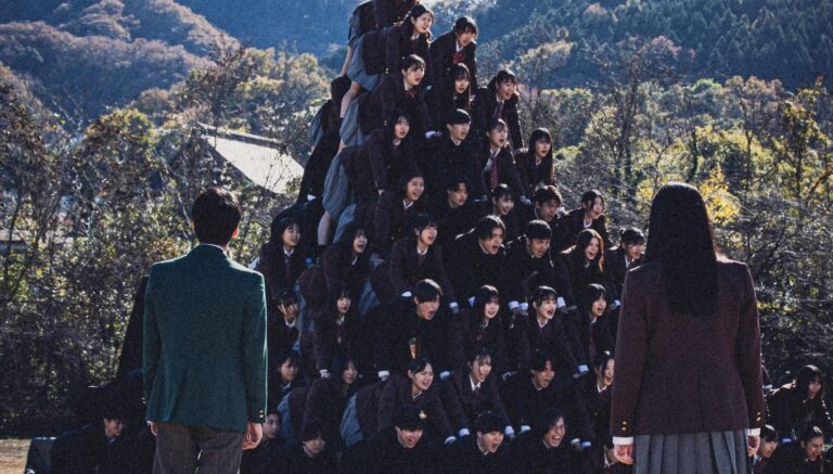 Auto Draft students climbing a pyramid formation outdoors in Japan.