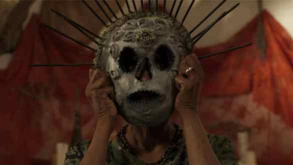 A haunting figure wearing a skull mask with spikes, evoking fear and unease.