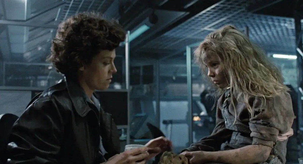 A woman and a girl with disheveled hair in a dark, industrial setting, appearing tense and distresse.