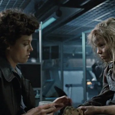 A woman and a girl with disheveled hair in a dark, industrial setting, appearing tense and distresse.