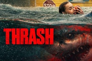 A woman swimming away from a large, menacing shark in murky water.