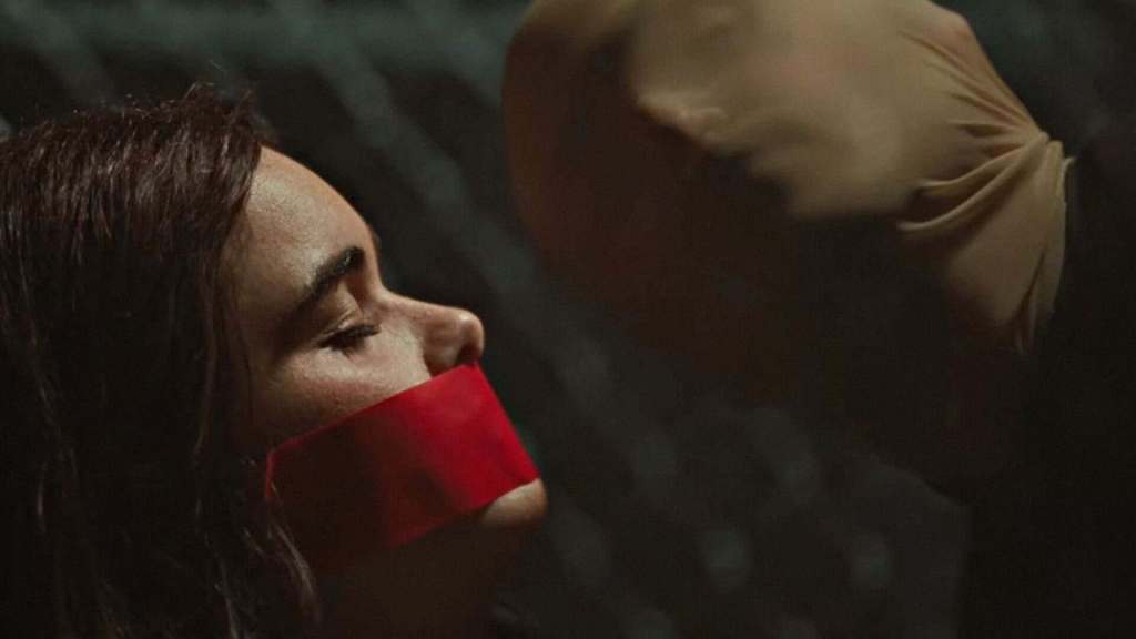 Disturbing woman with red tape over mouth, dark background, horror scene, fear, suspense, thriller i.