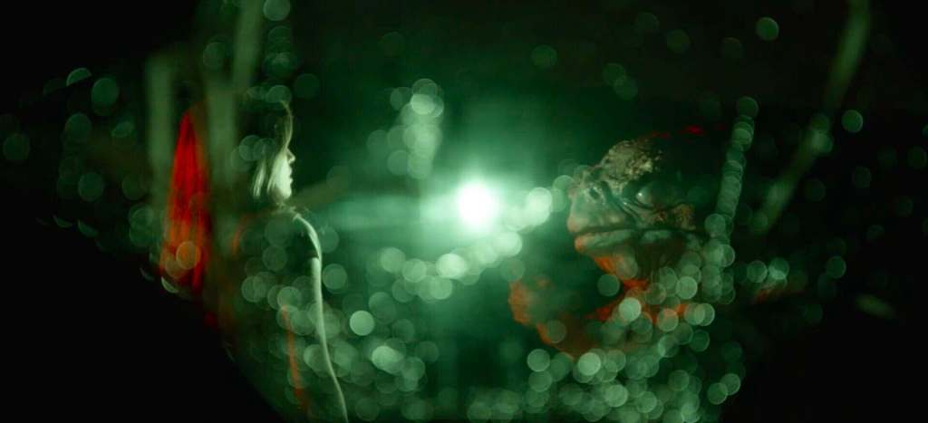 Futuristic scene with glowing green lights and a mysterious figure in darkness.