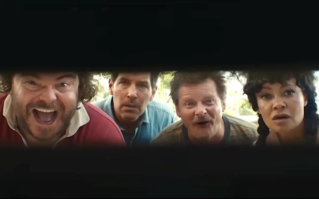 Four surprised people look through a small opening in a dark surface.
