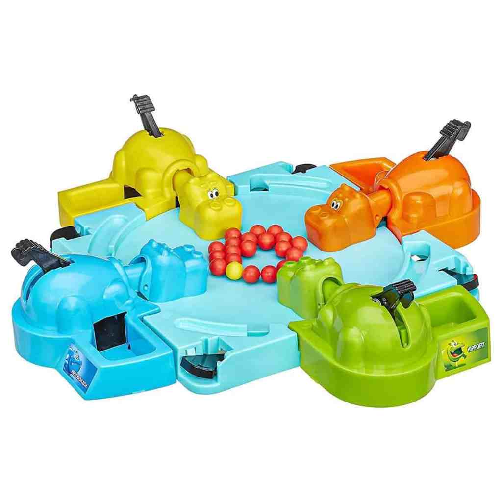 Colorful Hungry Hungry Hippos game with plastic hippo figures and red balls.