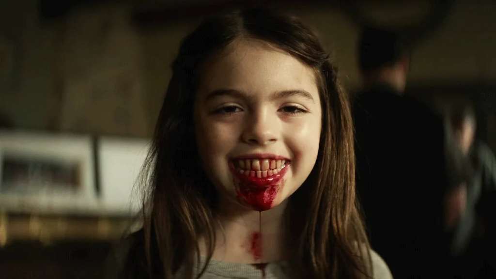 Young girl with blood on her lips and a creepy smile, horror movie scene.
