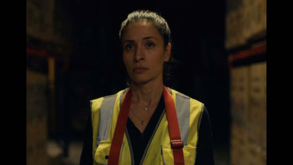 Woman in safety vest in dark warehouse for The Scariest Things.