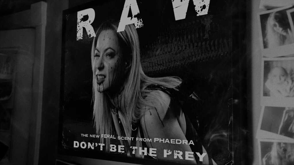 Black and white poster of a woman with a fierce expression for 'Don't Be The Prey' horror film.