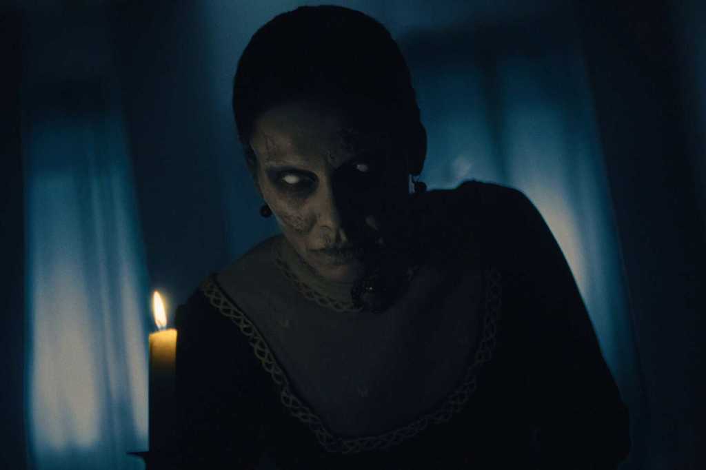 Eerie ghostly figure with glowing eyes in a dark room with candlelight.