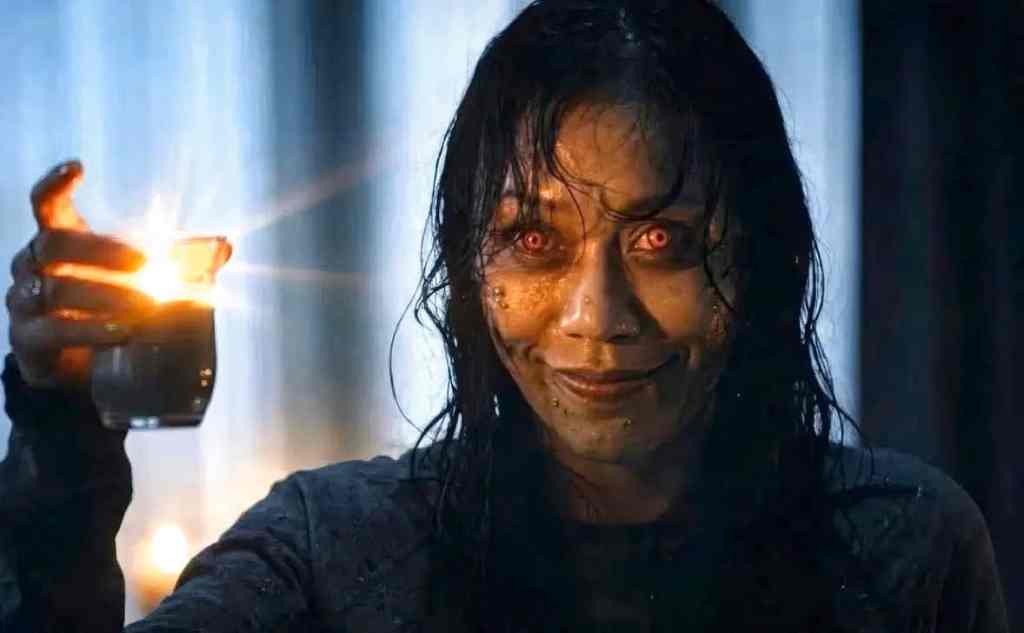 Evil Dead-inspired horror scene with a possessed woman holding a lit lighter.
