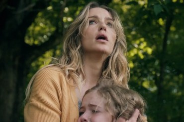 Woman and child in a forest, looking up with concern and fear.