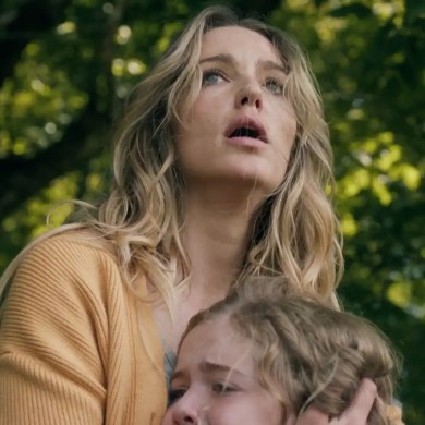 Woman and child in a forest, looking up with concern and fear.
