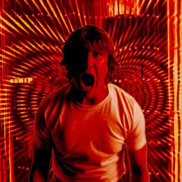 Scared man in a tunnel of red and orange light effects.