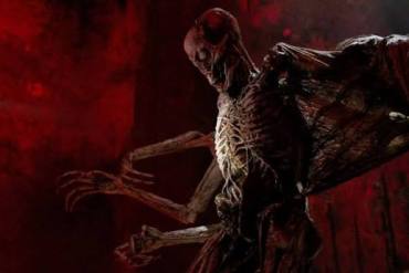 Eerie alien creature with skeletal features in a dark, ominous setting.