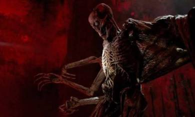 Eerie alien creature with skeletal features in a dark, ominous setting.