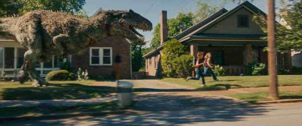 A giant dinosaur chasing two children on a suburban street.