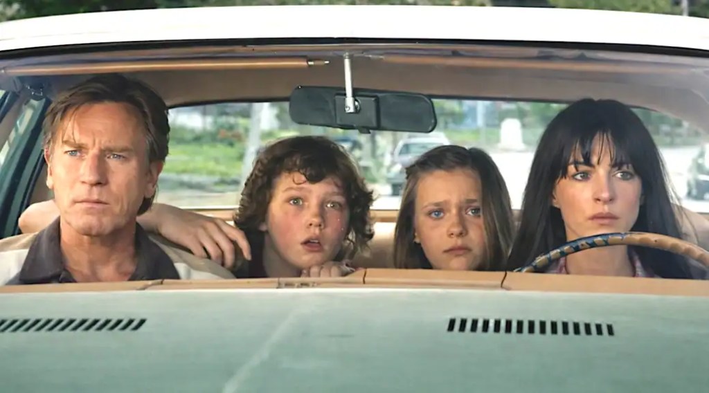 Family inside a car looking worried, from The End of Oak Street review.