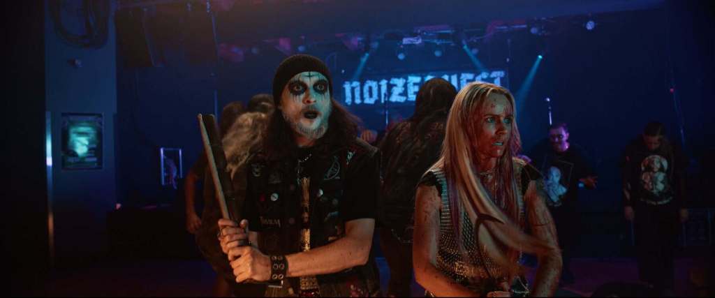 Costumed performers with zombie makeup at a horror-themed event.
