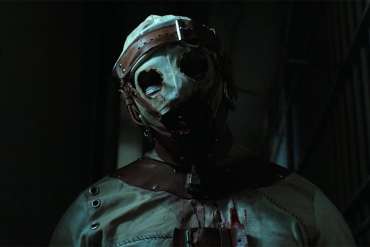 Eerie masked figure in a dark, horror-themed setting with bloodstains.