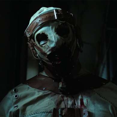 Eerie masked figure in a dark, horror-themed setting with bloodstains.