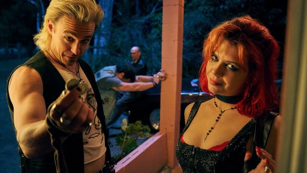 Two women with red and blonde hair in a porch scene from Penny Lane is Dead review.