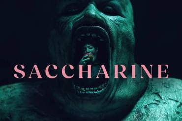 Horrific creature with open mouth and sharp teeth, dark horror theme.