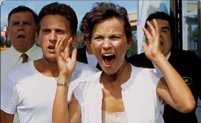 Group of people reacting with fear and shock in a scene from a horror movie.