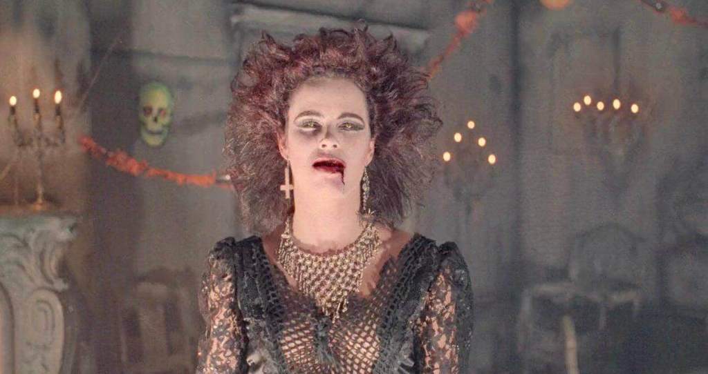 Gothic woman with wild hair and spooky makeup in haunted house setting.