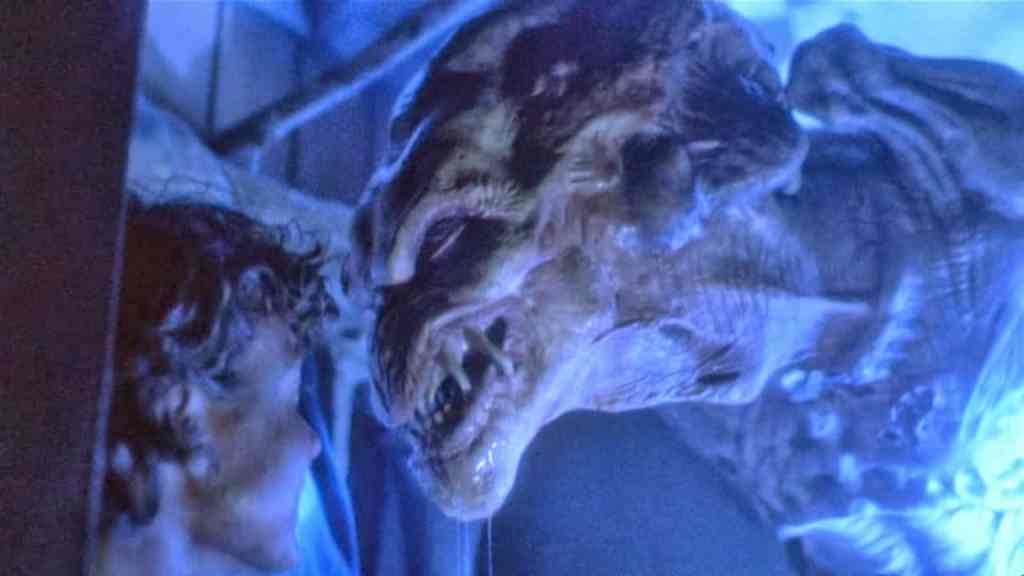 Fierce alien creature with sharp teeth and glowing eyes in a sci-fi scene.