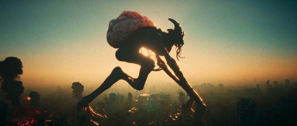 Giant monstrous creature with a backpack over a city skyline at sunset.